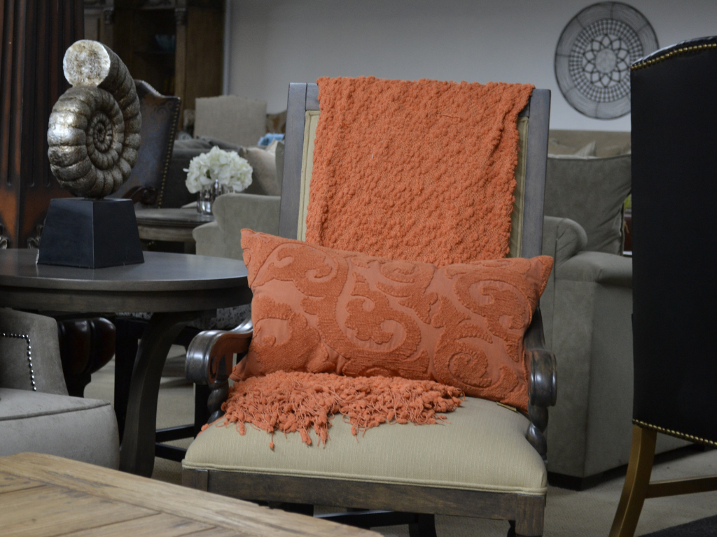 Here, we’ve styled the chair with a rich terracotta throw and a coordinating decorative pillow, bringing in a warm, seasonal tone that instantly transforms the corner into a cozy reading nook or conversation spot. Whether you're going for rustic charm, transitional elegance, or a modern eclectic mix, this chair is as versatile as it is beautiful.